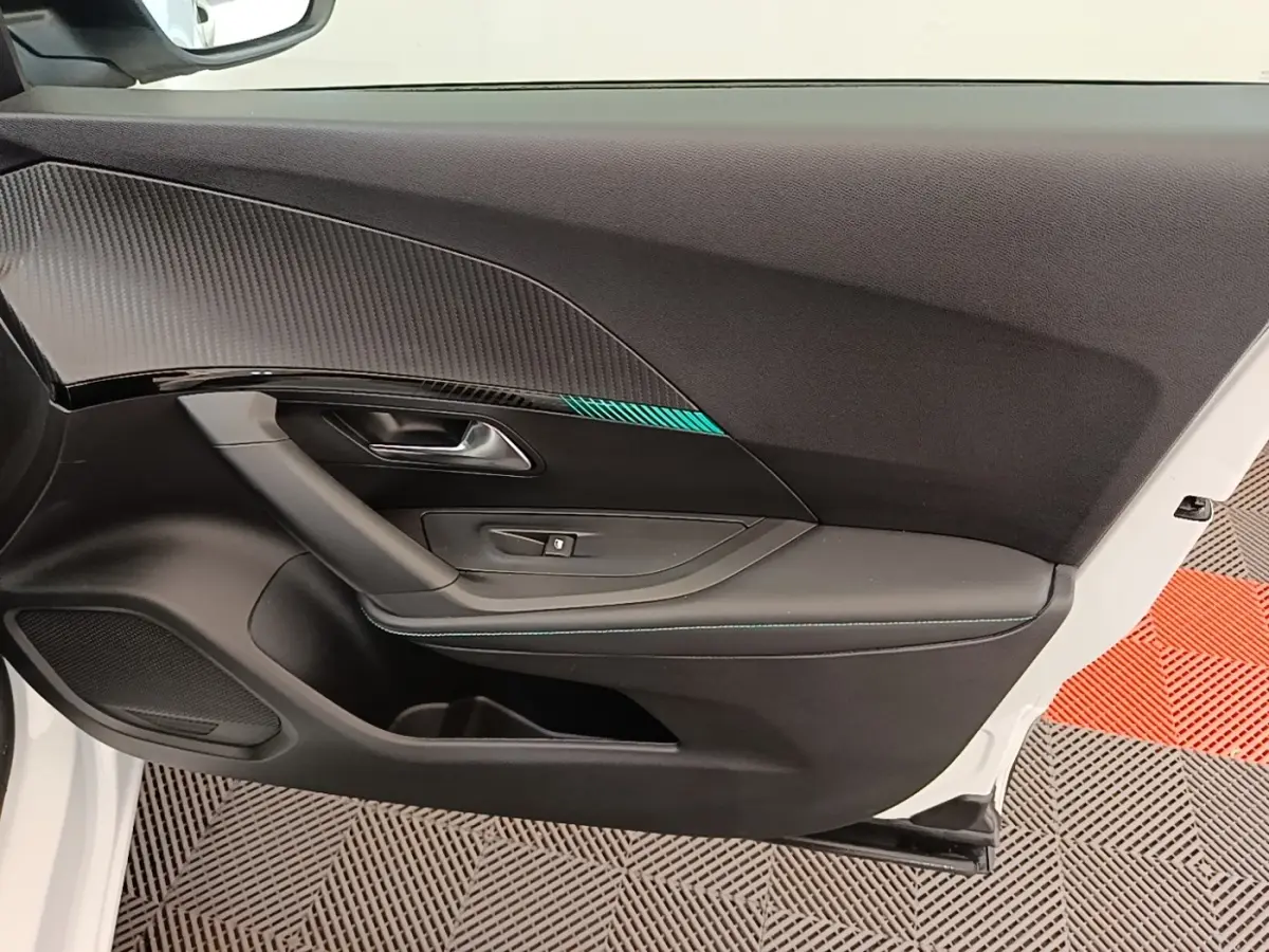 Vue intérieure de la porte avant gauche blanche du Peugeot 2008 avec insert décoratif noir et bleu.