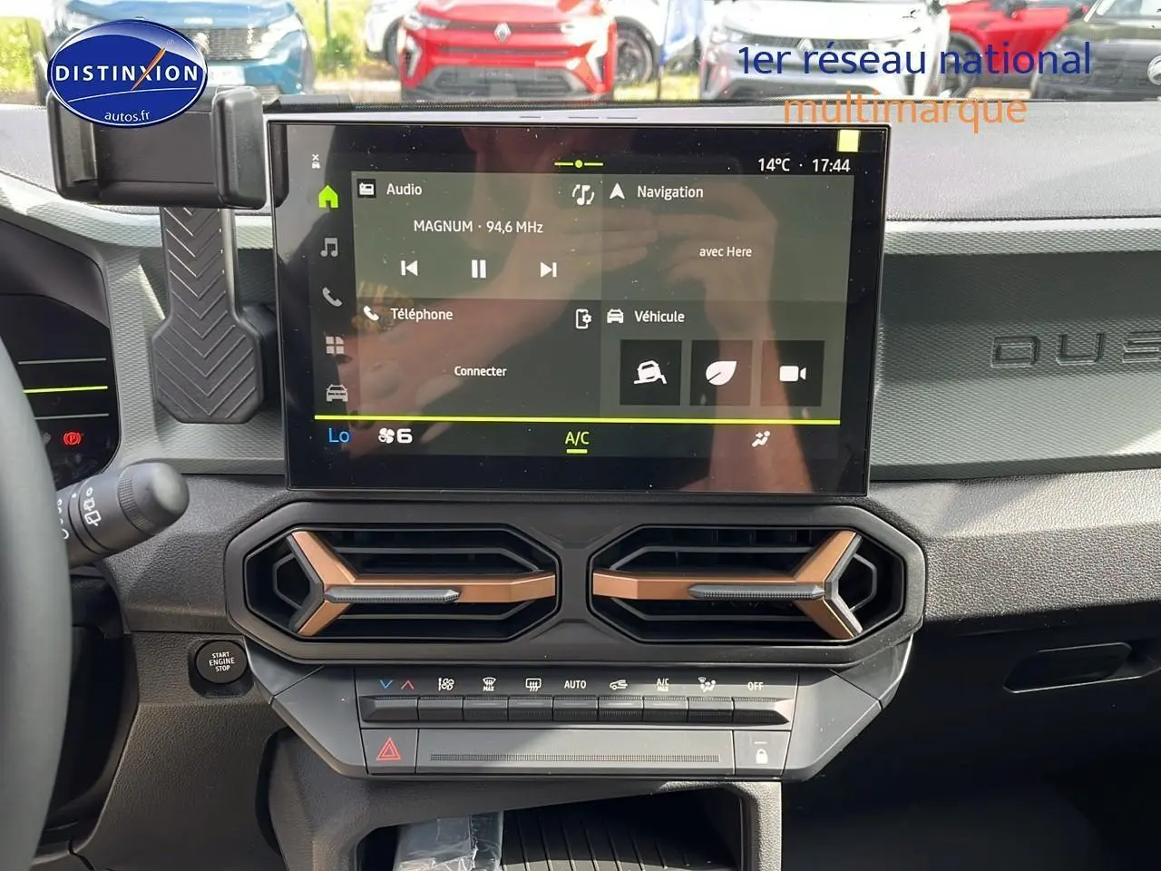 Tableau de bord du Dacia Duster 2025 Sandstone, vue frontale sur l'écran tactile et les aérateurs hexagonaux.