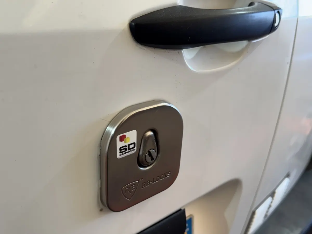 Gros plan sur la serrure de sécurité RB-Locks sur la porte blanche côté gauche d’un Citroën Berlingo 2020.