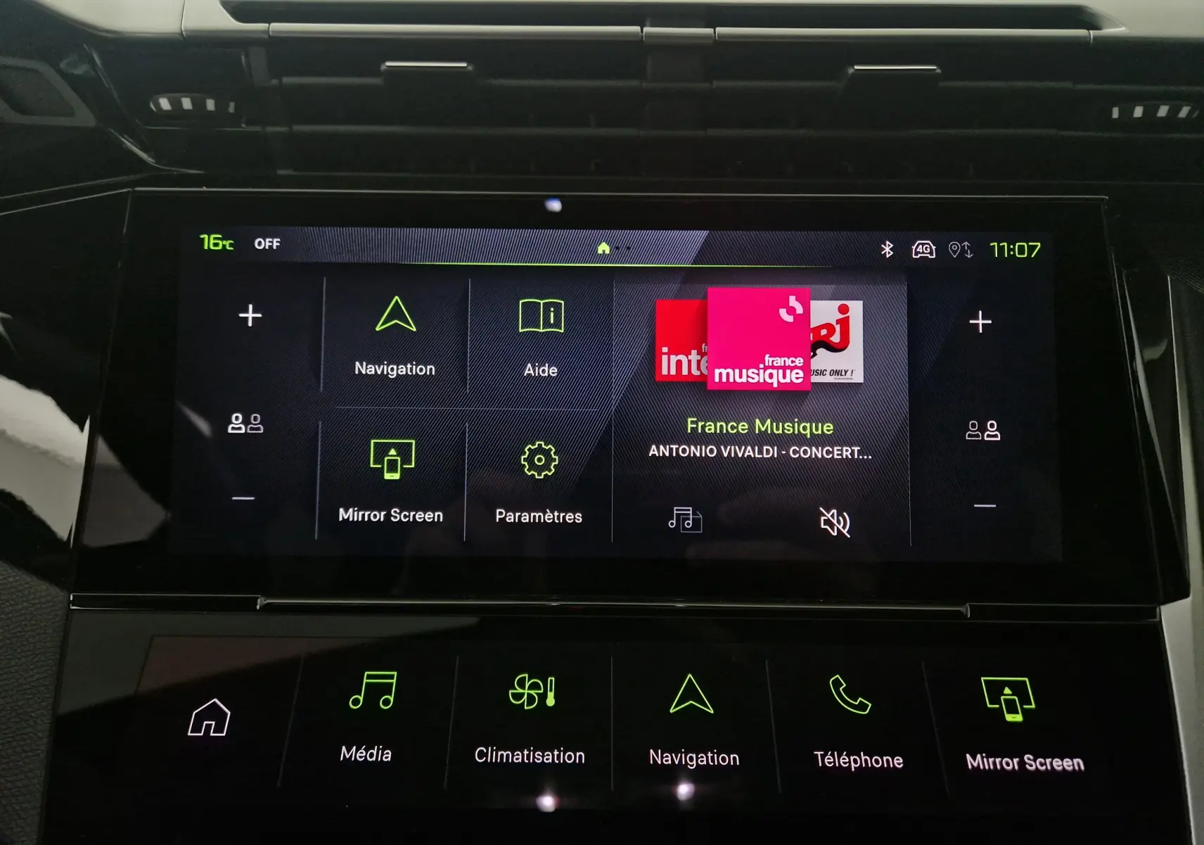 Écran tactile central du tableau de bord de la Peugeot 308 blanc Okenite, affichant navigation et musique France Musique.