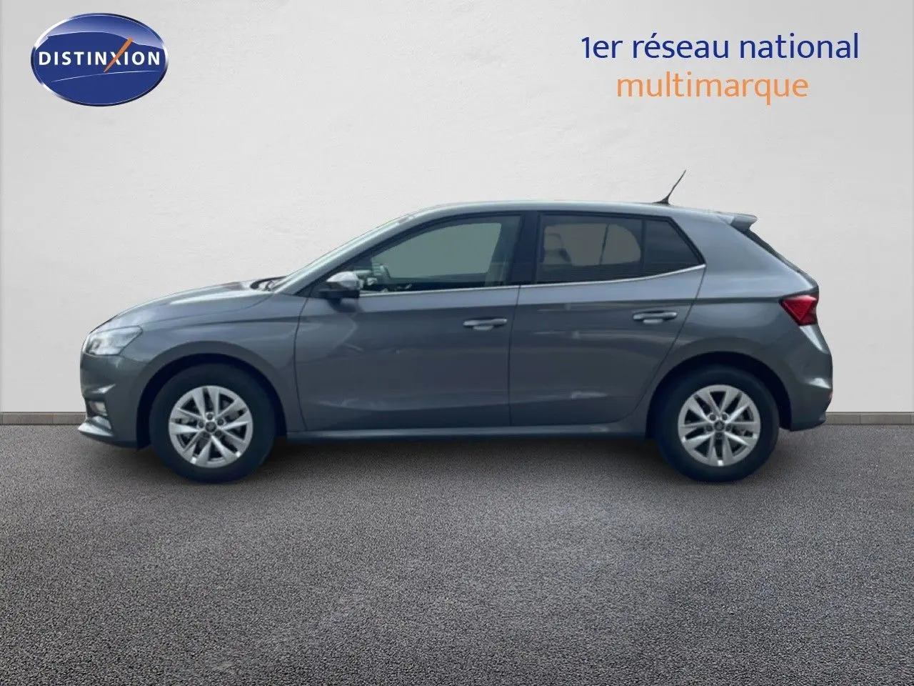 Vue de profil côté gauche d'une Skoda Fabia gris graphite métal avec jantes alliage et vitres teintées.