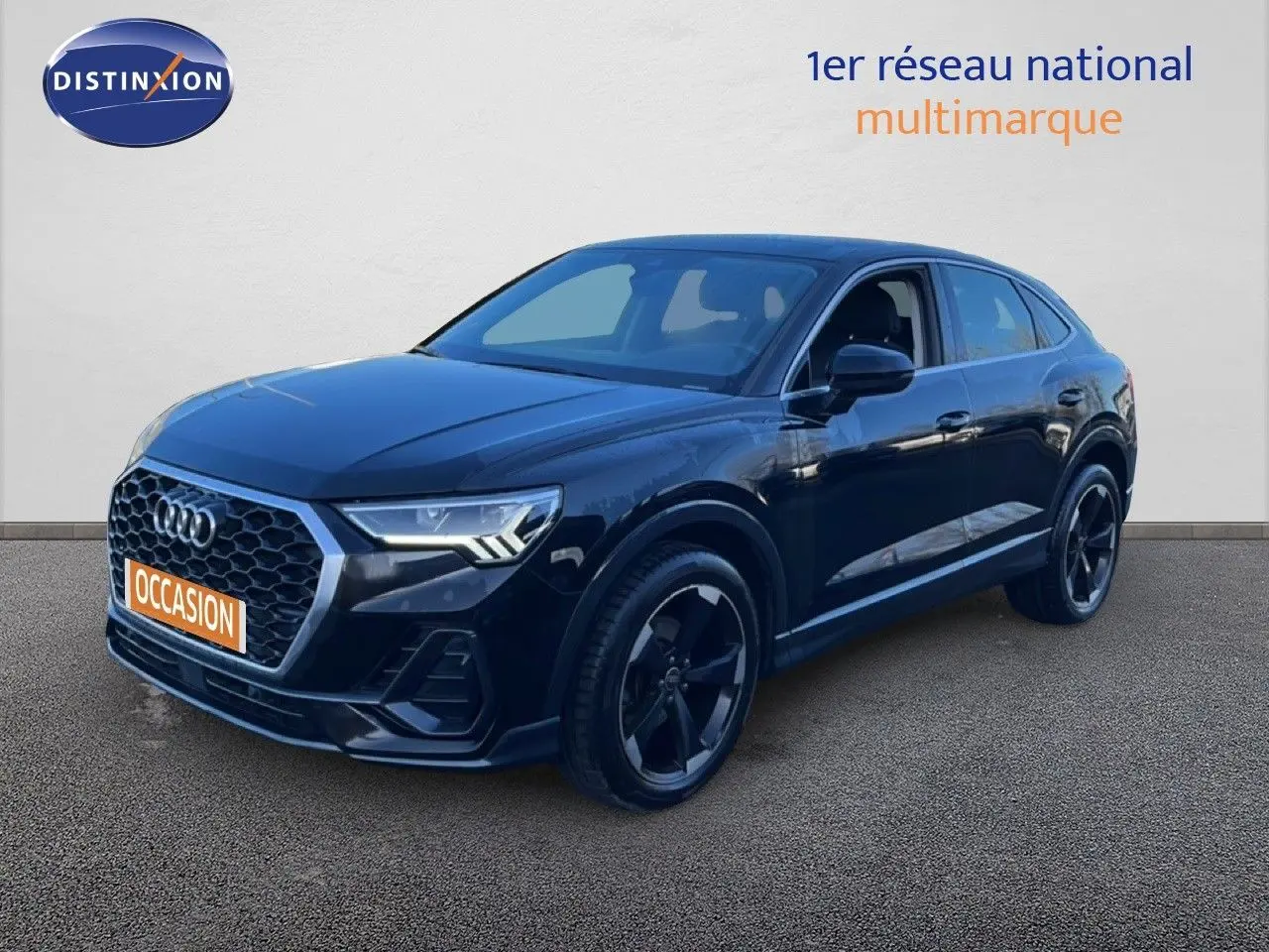 Audi Q3 Sportback noir en 3/4 avant droit, avec calandre hexagonale et jantes noires distinctives.