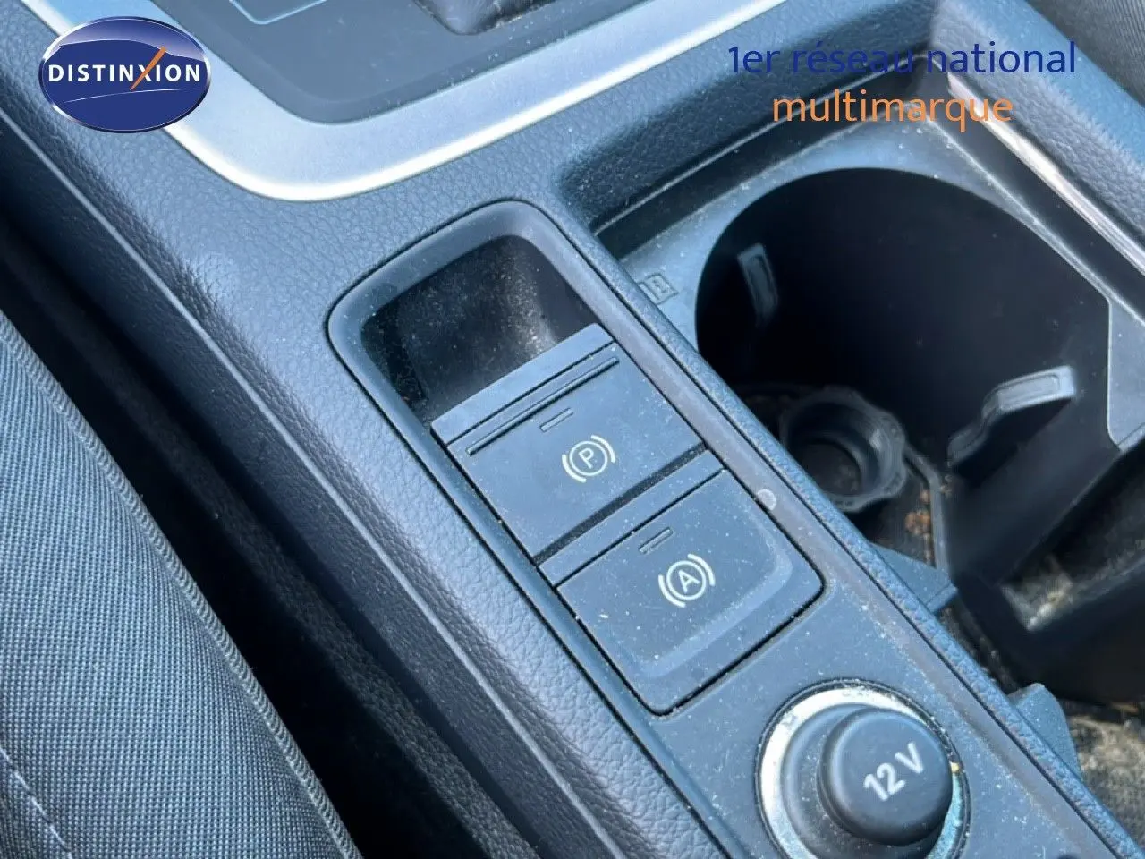 Gros plan sur la console centrale noire de l'Audi Q3 Sportback 35 TDI 2022, montrant les commandes de frein à main et prise 12V.