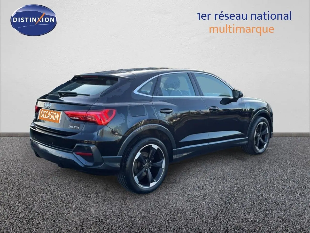 Audi Q3 Sportback noir vue 3/4 arrière droit, mettant en valeur ses lignes dynamiques et ses jantes noires.