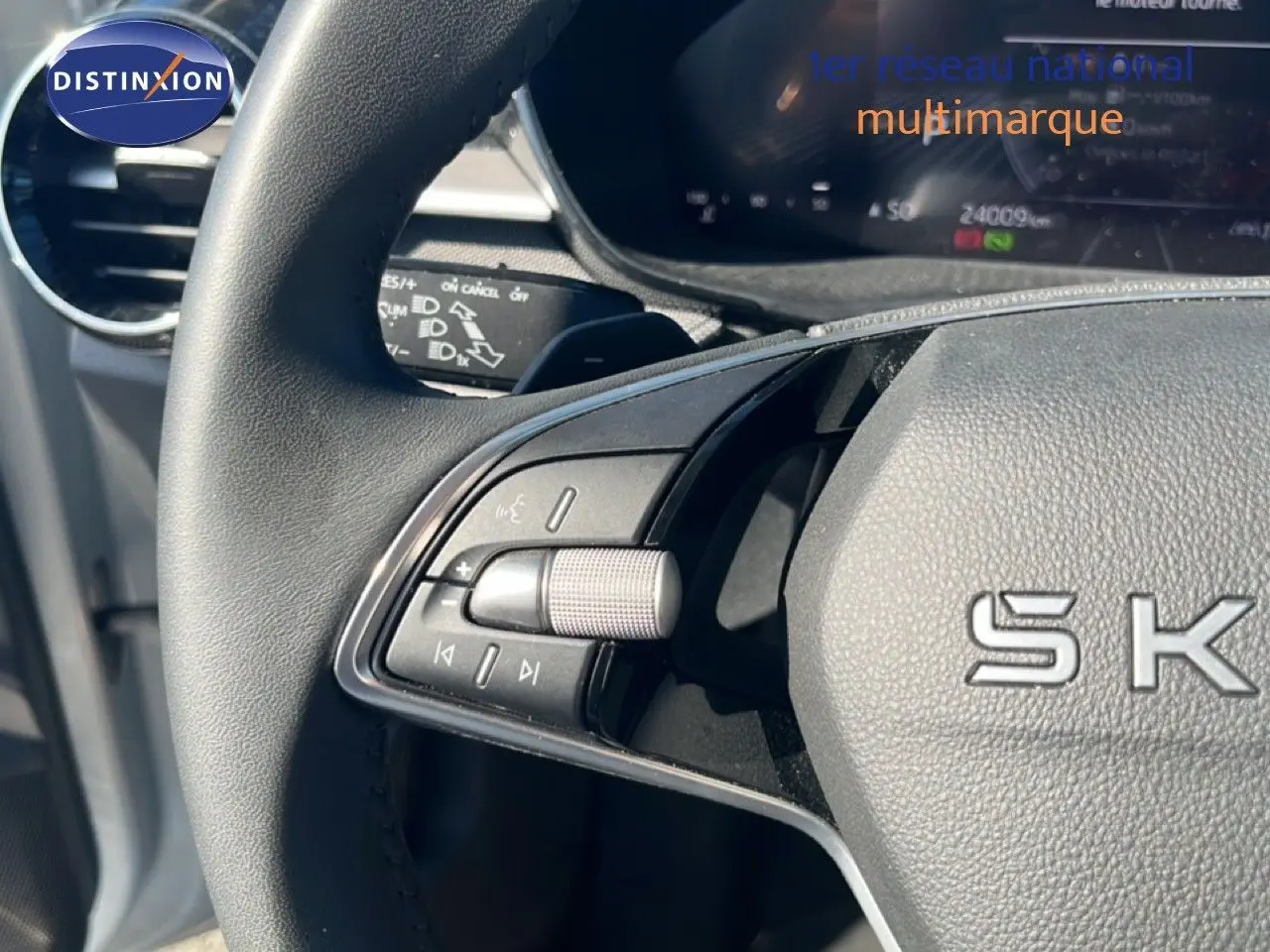 Gros plan sur le volant noir de la Skoda Fabia 2025, montrant les commandes multimédia côté gauche et le tableau de bord digital.
