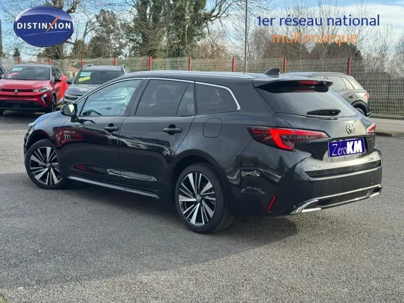 Toyota Corolla 1.8 Hyb Sport Pack Tech noire vue 3/4 arrière droit, jantes alu et feux LED distinctifs.