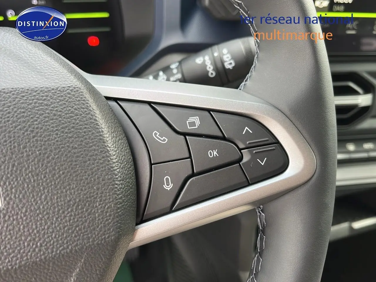 Gros plan sur les commandes multifonctions à droite du volant du Dacia Duster 2025, intérieur noir.