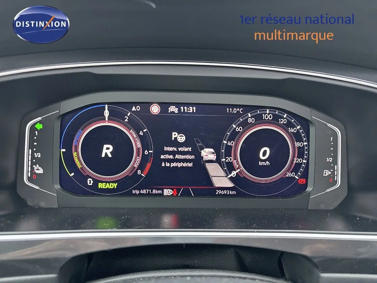 Tableau de bord numérique du Volkswagen Tiguan hybride rechargeable 2022 affichant la vitesse, régime et alertes au centre.