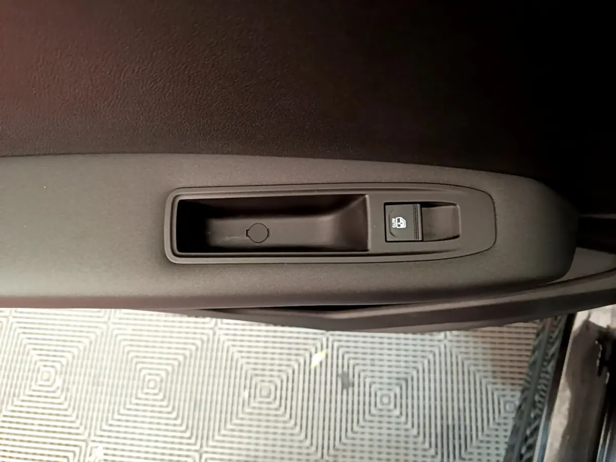 Détail de la commande de verrouillage des vitres sur la portière intérieure côté conducteur d'un Renault Captur Business noir 2021.
