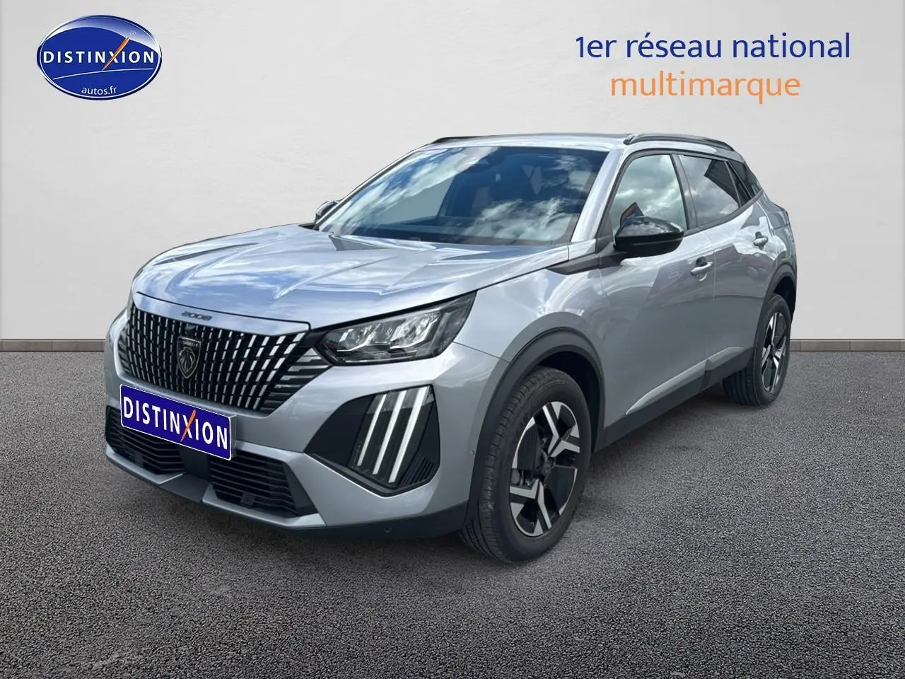 Peugeot 2008 gris artense en 3/4 avant droit, avec calandre distinctive et jantes alu bicolores.