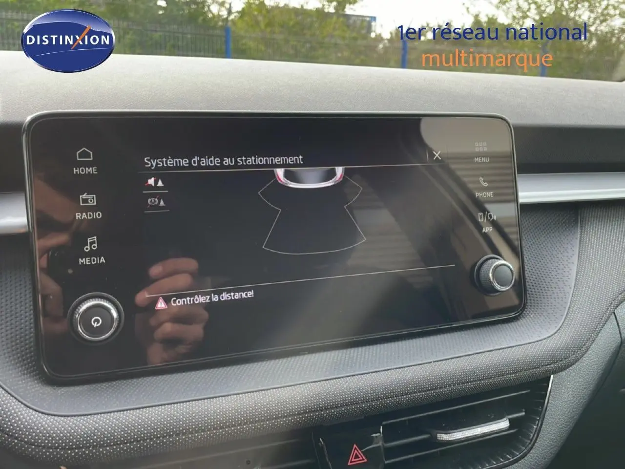 Écran tactile du système d’aide au stationnement dans l’habitacle d’une Skoda Fabia blanc glacier, vue de face.