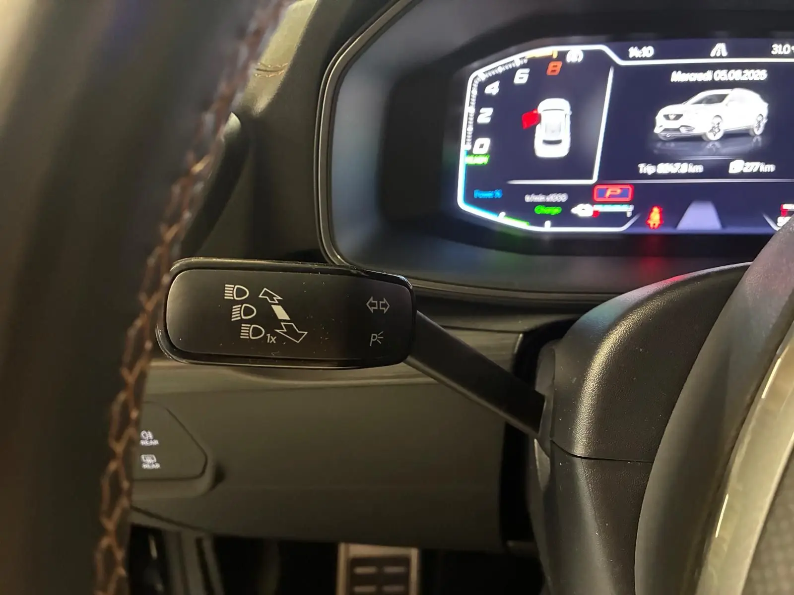 Gros plan sur le commodo gauche du volant du CUPRA Formentor gris foncé mat, avec tableau de bord numérique en arrière-plan.