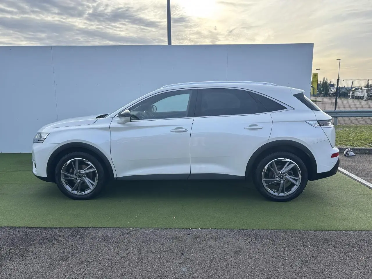Profil côté gauche du SUV blanc DS7 Crossback 2021 avec vitres arrière surteintées et jantes alliage.