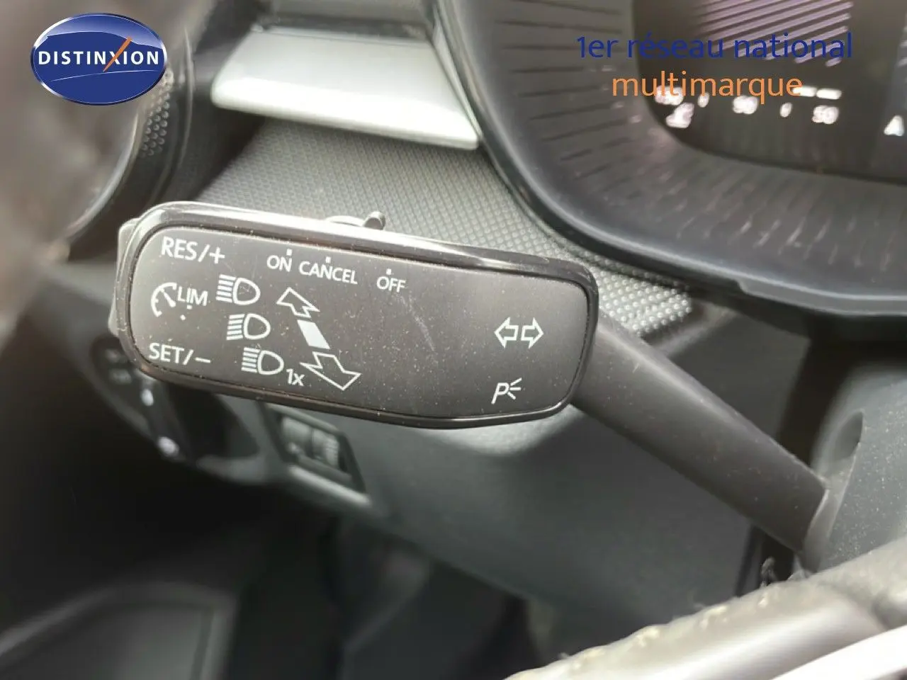 Gros plan sur la commande de régulateur de vitesse dans l'habitacle d'une Skoda Fabia blanche glacier 2025.