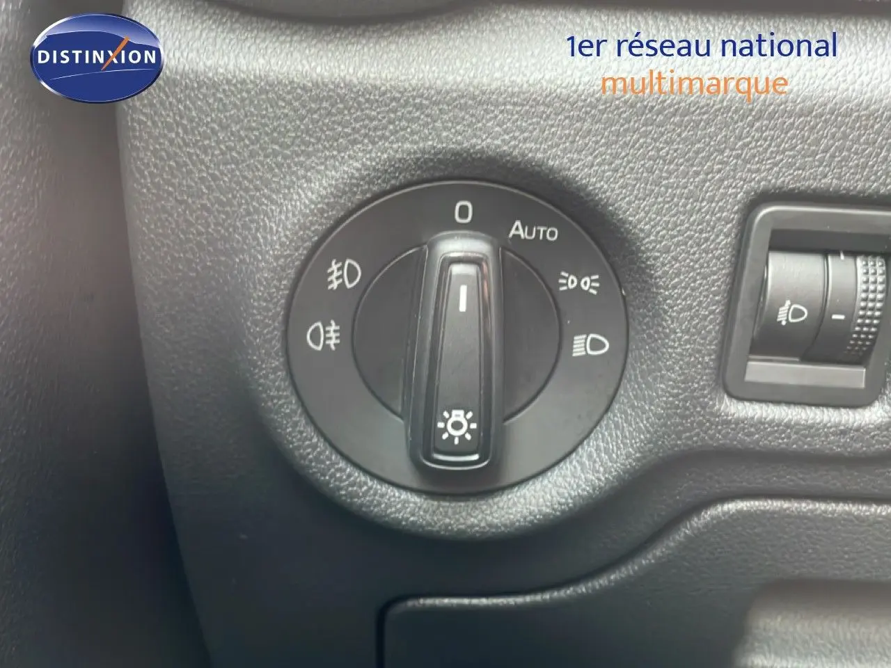Gros plan sur le sélecteur de phares noir dans l’habitacle d’une Skoda Fabia blanche Glacier 2025.