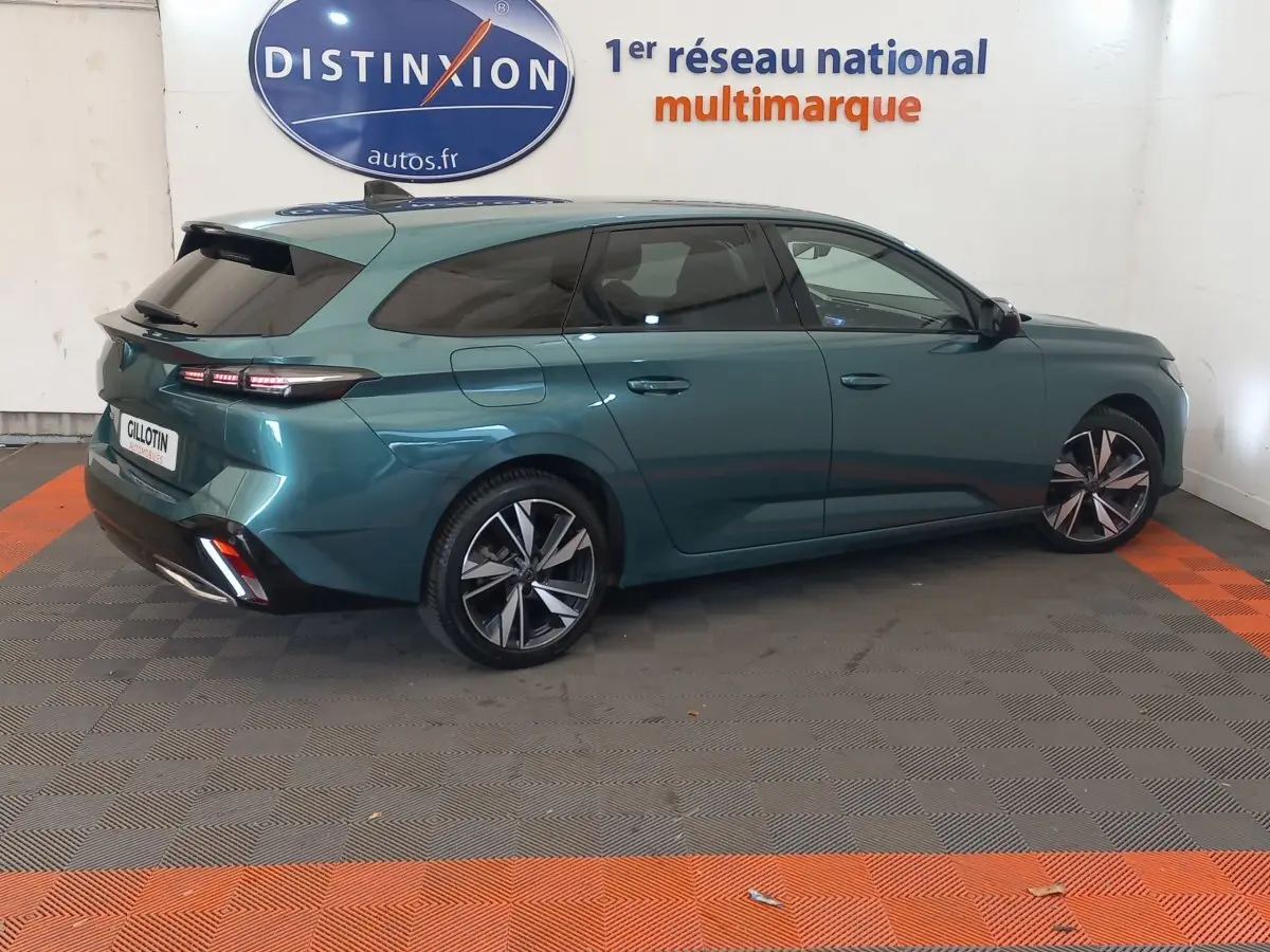 Peugeot 308 PureTech 130 bleu vue de profil côté droit, avec vitres teintées et jantes alliage distinctives.