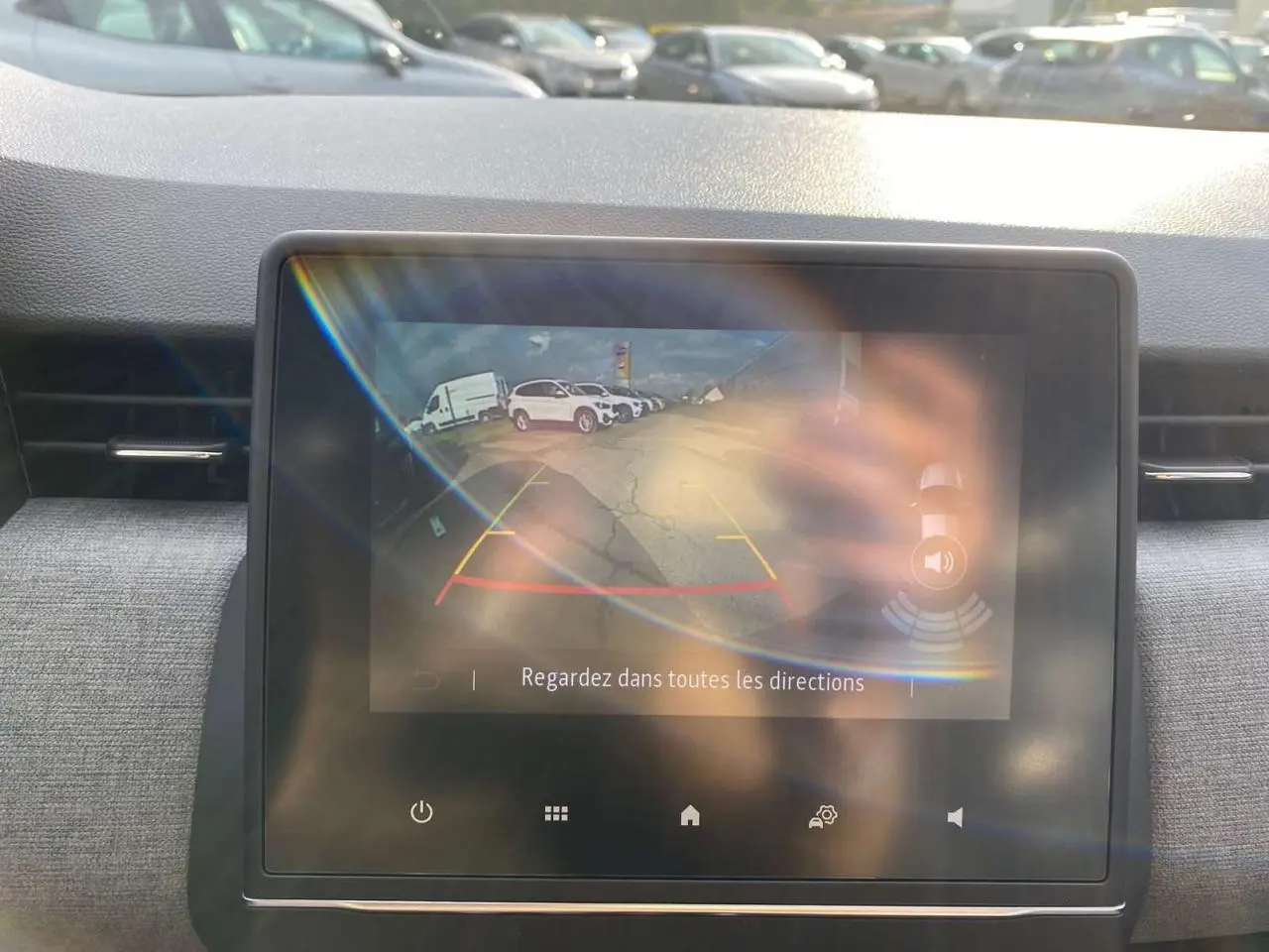 Écran tactile de la Renault Clio 2025 montrant l'image de la caméra de recul avec guidage coloré.