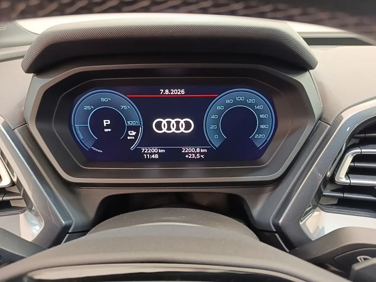 Vue rapprochée du combiné d'instruments numérique de l'Audi Q4 E-TRON Sportback affichant les compteurs et logo Audi.