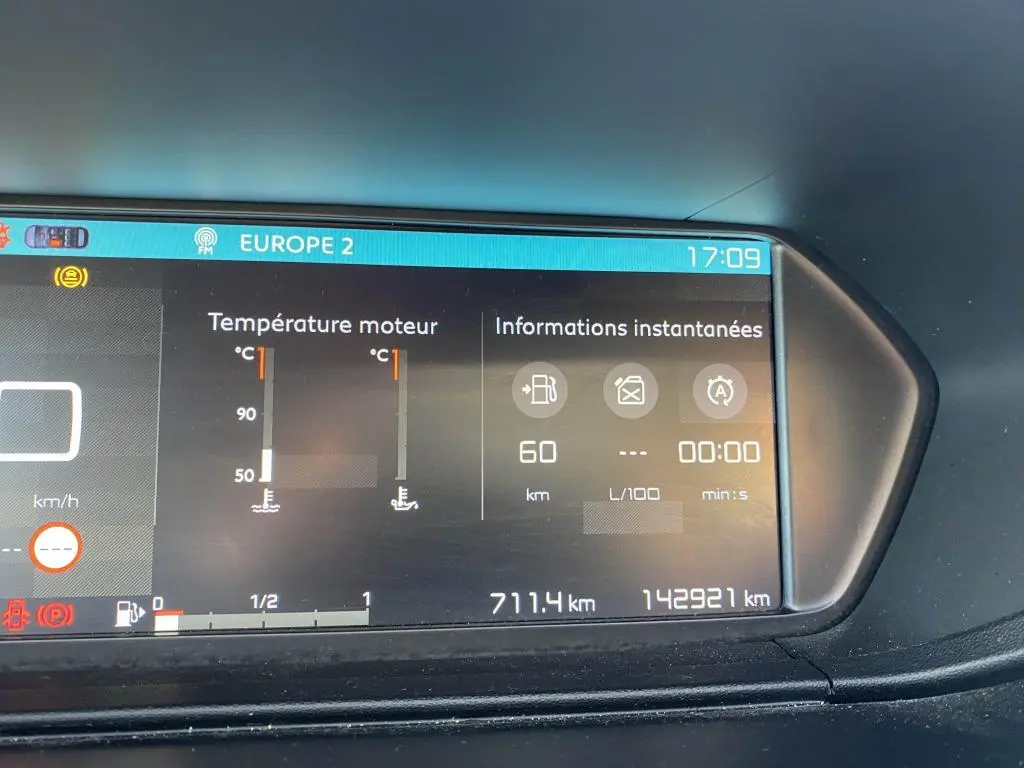 Affichage numérique du tableau de bord du Citroën C4 Spacetourer blanc, montrant la température moteur et l'autonomie.