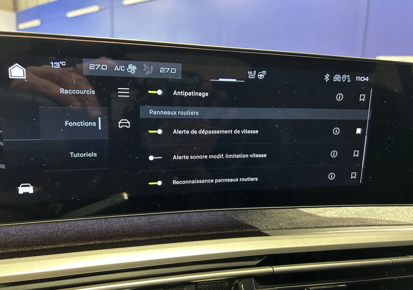 Écran tactile central du tableau de bord du Peugeot 3008 Hybrid 2026 affichant les menus de climatisation, navigation et aides à la conduite.