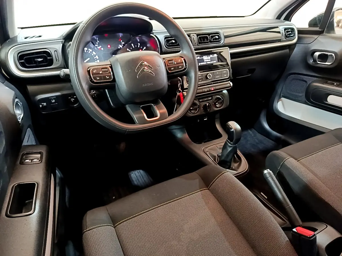 Intérieur de la Citroën C3 PureTech 68 BVM Feel 2018, vue du poste de conduite avec volant multifonction et tableau de bord noir.