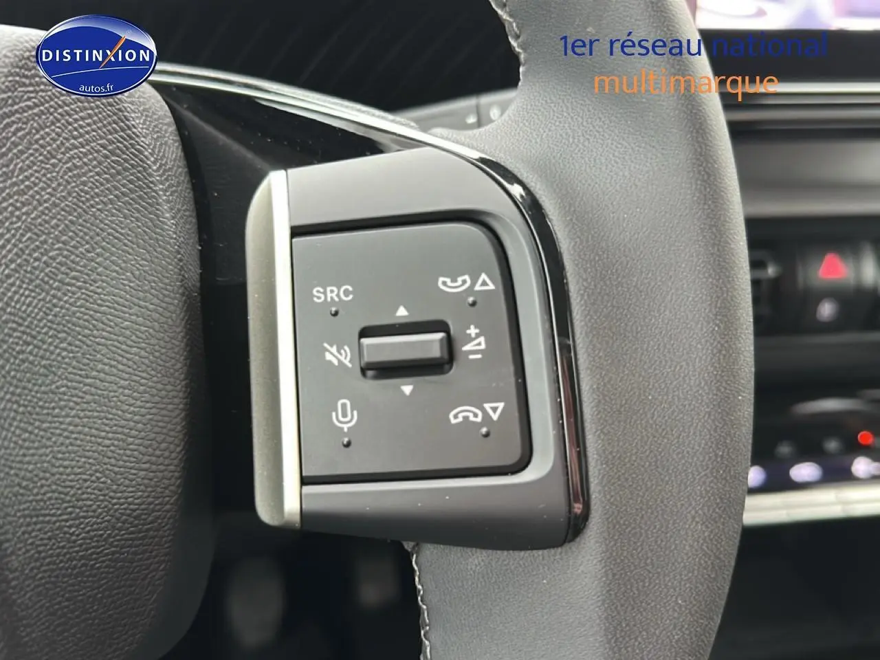 Gros plan sur les commandes vocales et audio au volant du Citroën C3 Aircross gris, intérieur moderne et épuré.
