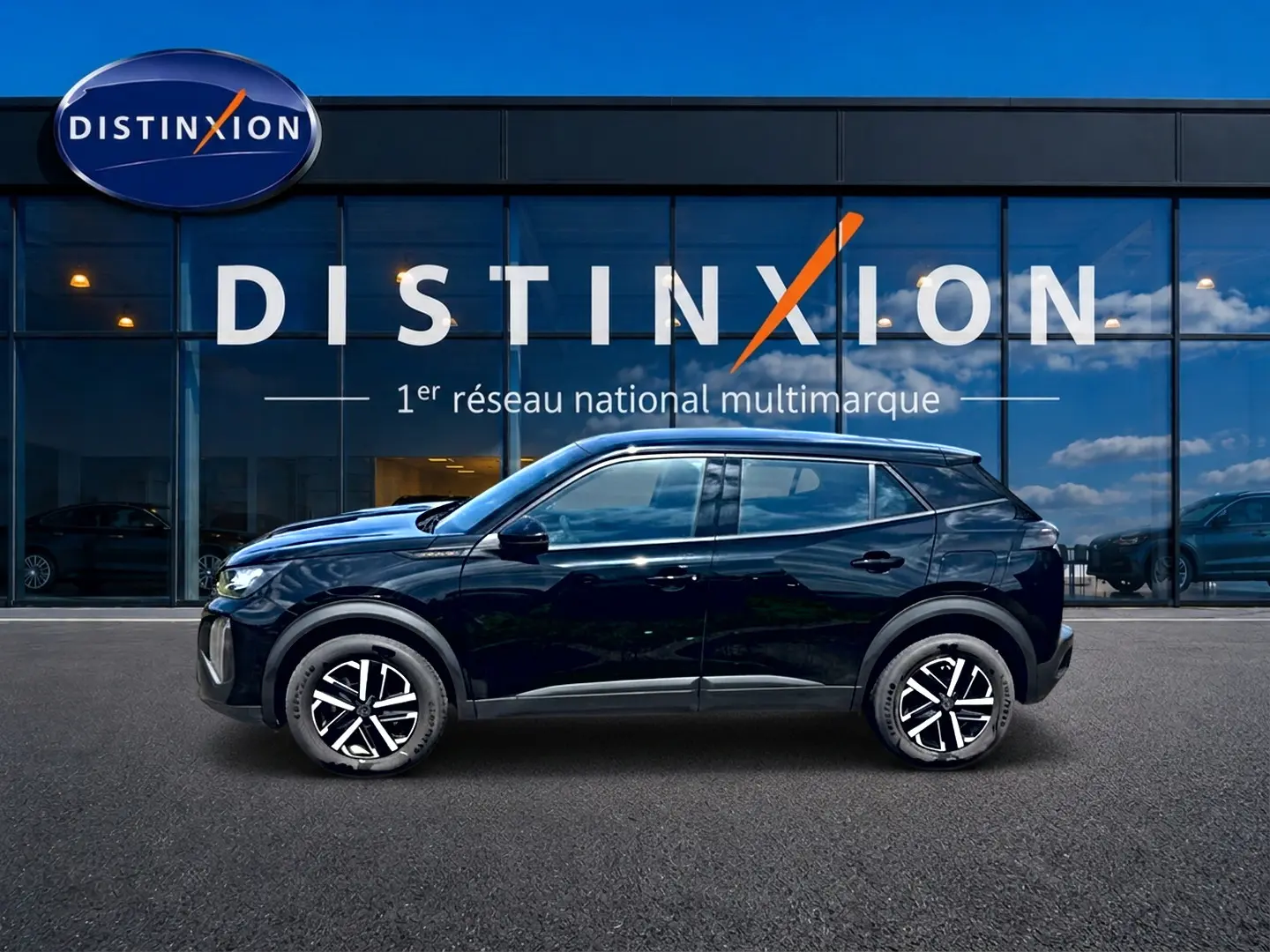 Profil côté gauche d’un Peugeot 2008 noir 2025 garé devant une vitrine avec logo Distinxion.