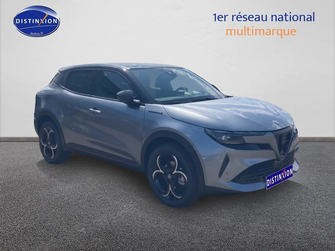 Vue 3/4 avant d'une Alfa Romeo Junior 1.2 hybride gris t/noir avec jantes alliage et vitres teintées.