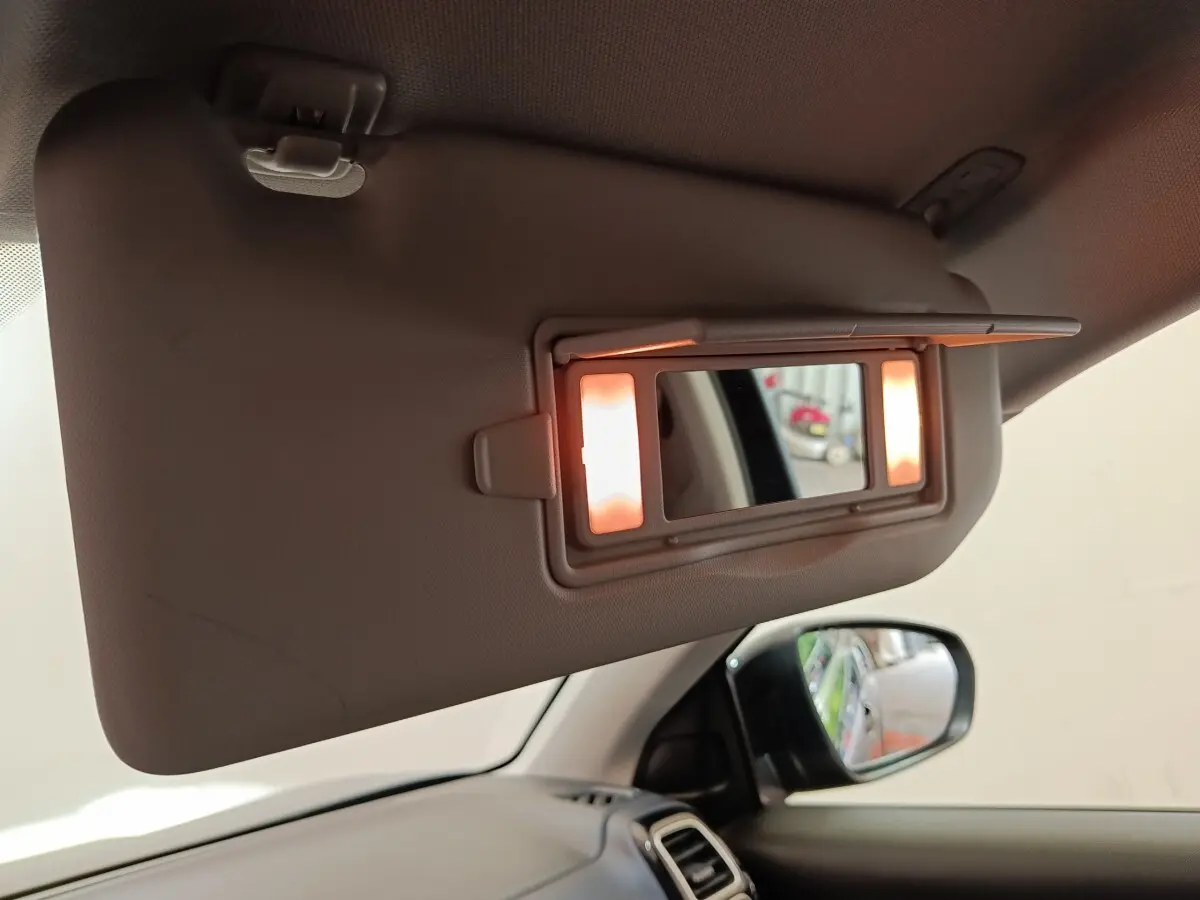 Miroir de courtoisie éclairé sur pare-soleil côté conducteur dans l’habitacle d’un Citroën C5 Aircross noir 2024.