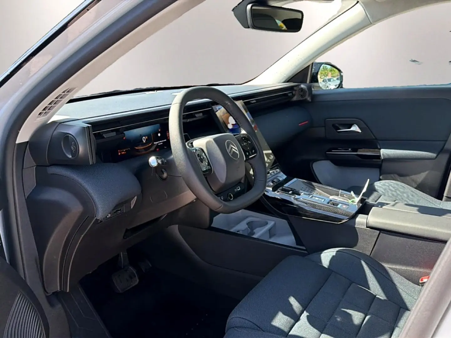 Intérieur du Citroën C5 Aircross 2026 vu côté conducteur, tableau de bord noir avec écran tactile et volant multifonction.