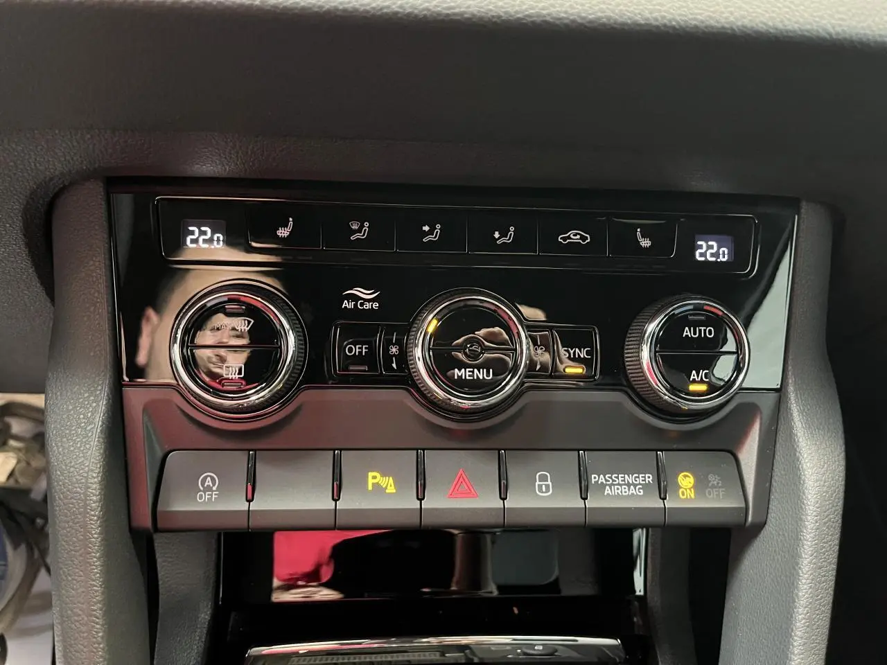 Panneau de commande de climatisation tri-zone noir brillant dans le Skoda Karoq blanc 2025 Sportline.