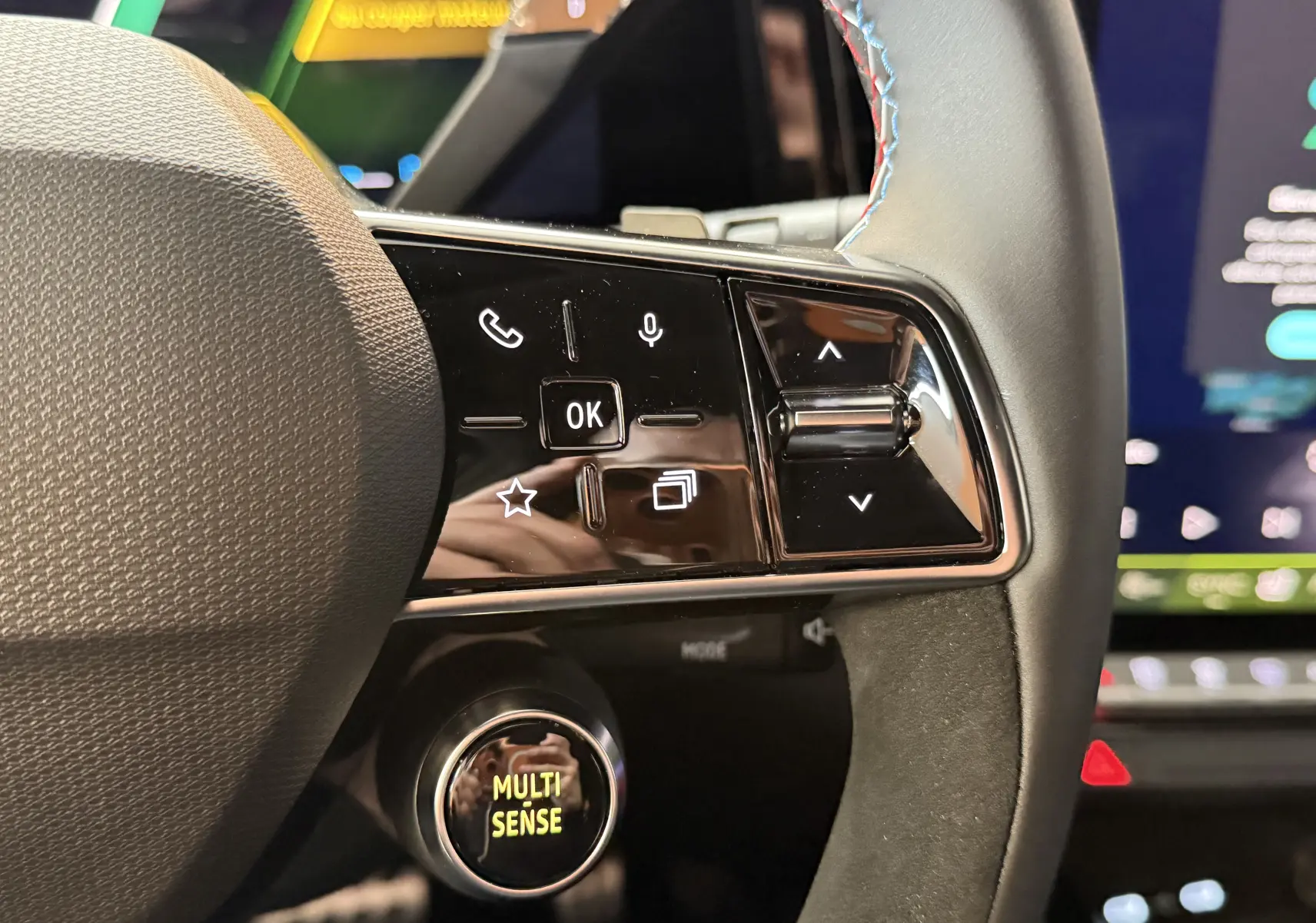 Gros plan sur les commandes à droite du volant du Renault Austral E-Tech 200 Esprit Alpine avec surpiqûres tricolores.