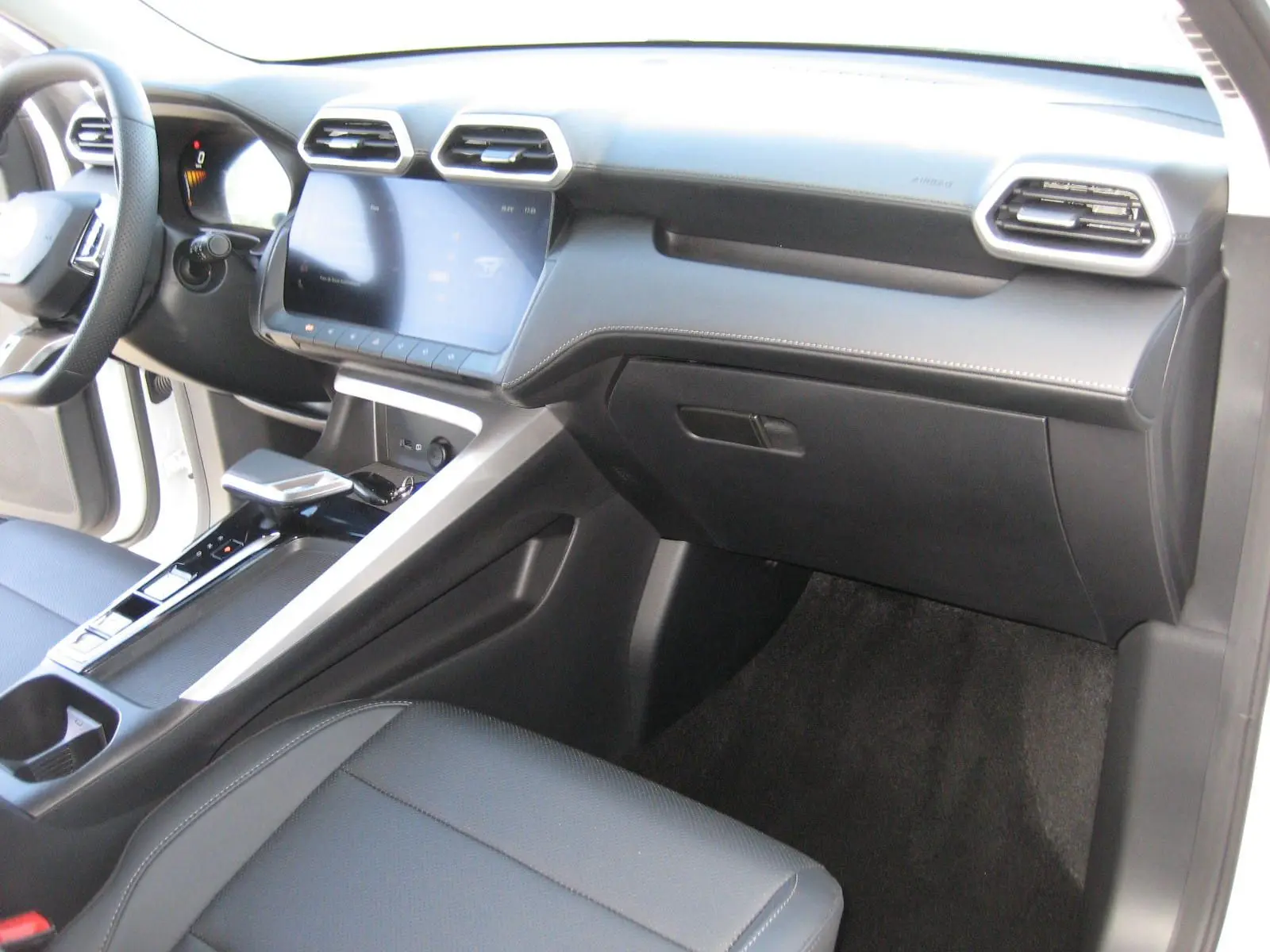 Vue intérieure côté passager du tableau de bord et console centrale noire du MG ZS 1.5 HYBRID+197 LUXURY 2026.