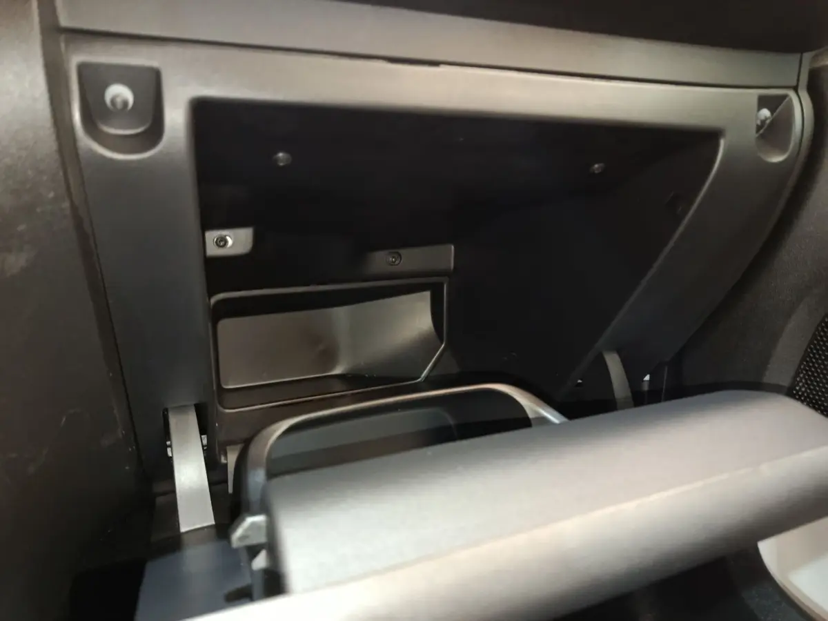 Détail de la boîte à gants réfrigérée ouverte dans l'habitacle noir d'une Citroën C3 blanche, vue de face.