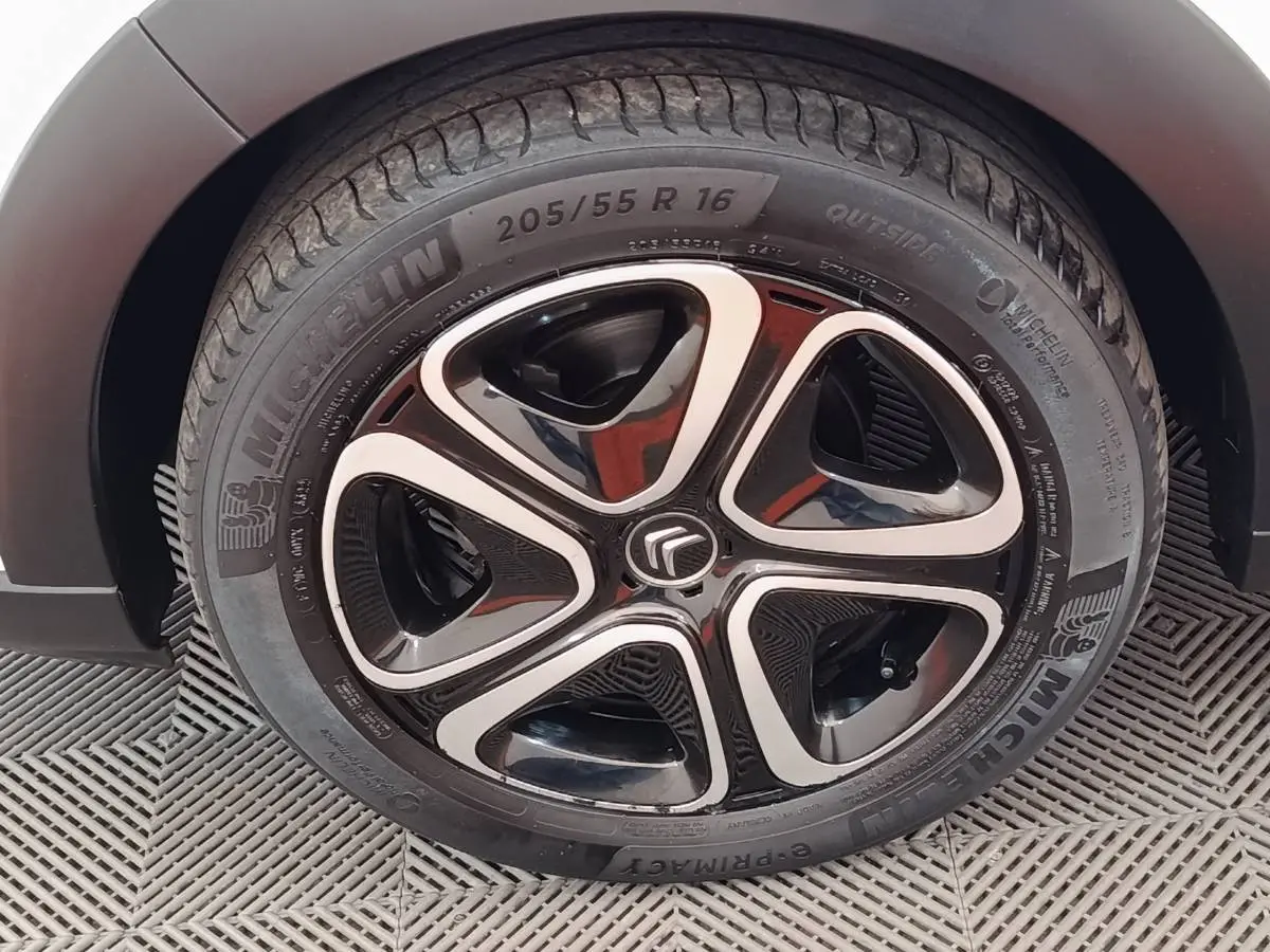 Gros plan sur la roue avant gauche de la Citroën C3 blanche, jante alliage noire et argentée avec pneu Michelin.