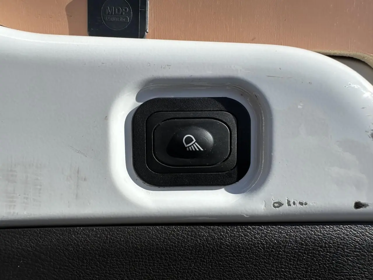 Gros plan sur l'interrupteur d'éclairage renforcé à LED du compartiment de chargement du Ford Transit Fourgon blanc.