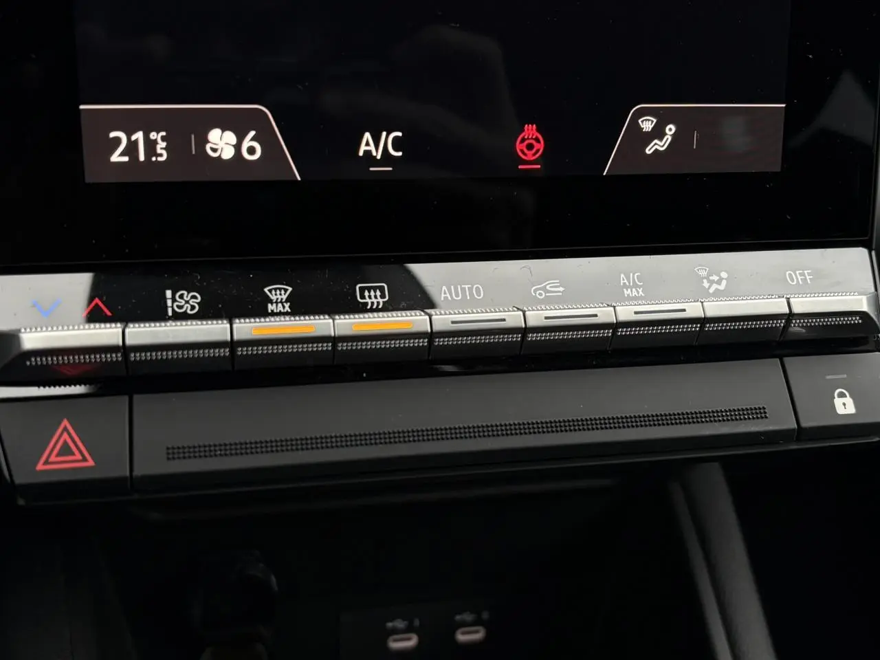 Vue rapprochée du tableau de bord du Renault Captur blanc nacré 2025, montrant les commandes de climatisation et l'écran digital.