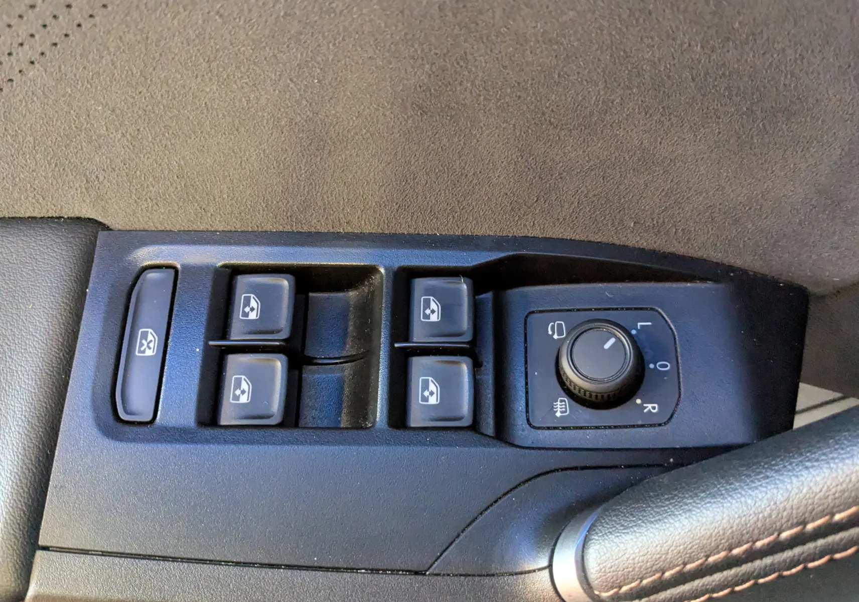 Gros plan sur les commandes de lève-vitres et réglage des rétroviseurs côté conducteur d’une CUPRA Formentor gris métallique.