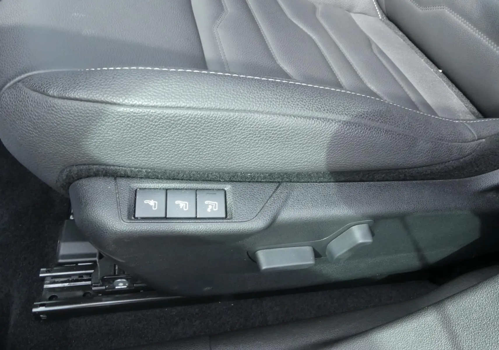 Détail des commandes électriques du siège conducteur en cuir noir du Jeep Avenger 2024, vue côté gauche.