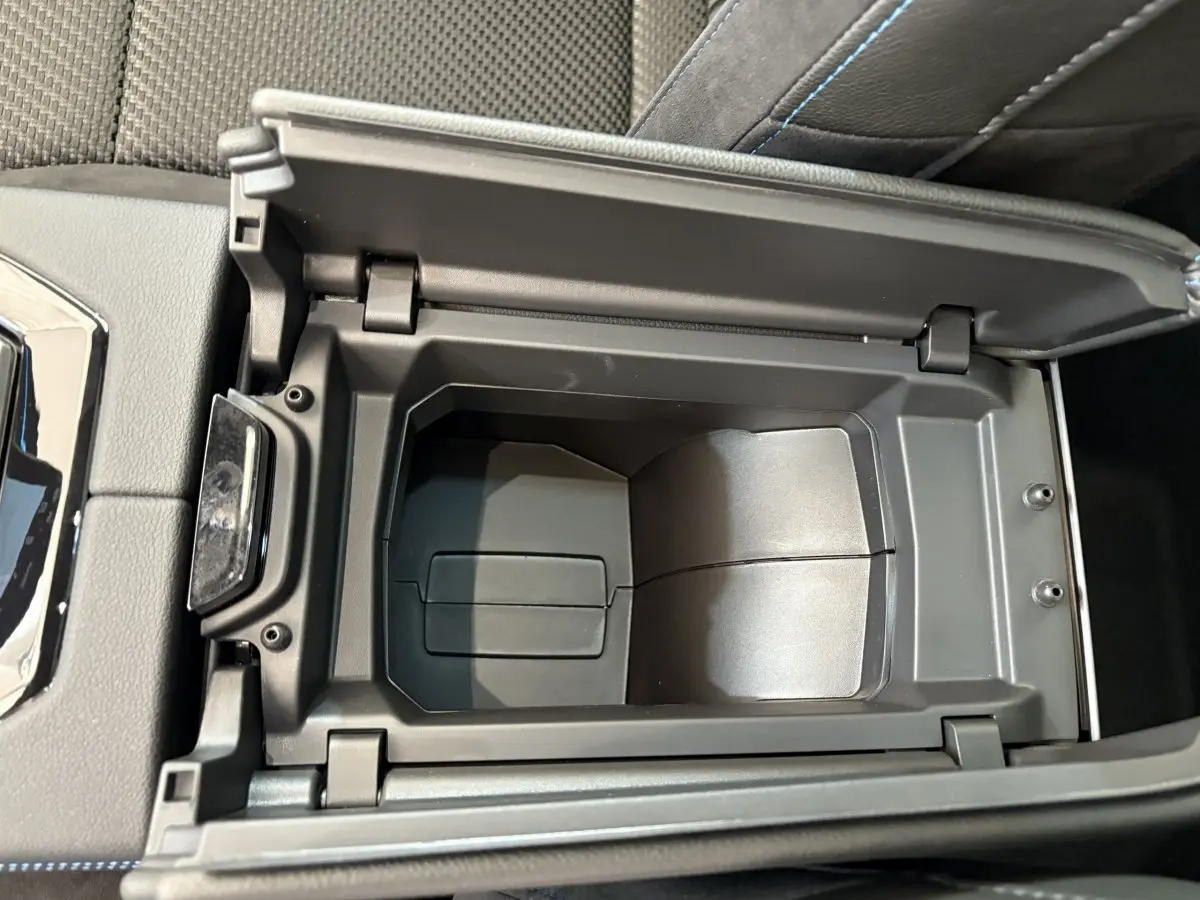 Vue plongeante sur le rangement central ouvert du Renault Espace blanc esprit Alpine 7PL E-Tech 2025, intérieur noir.