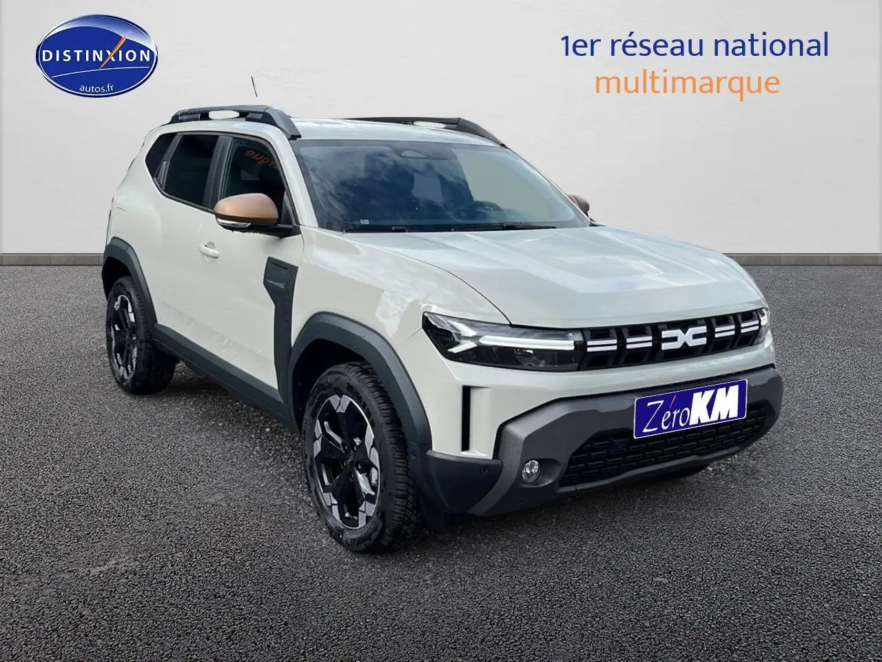 SUV Dacia Duster 2025 couleur Sandstone en 3/4 avant droit avec jantes noires et rétroviseurs cuivrés.