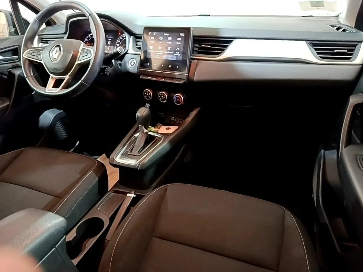 Vue intérieure avant du Renault Captur Business 2021, volant multifonctions noir et écran tactile central visible.