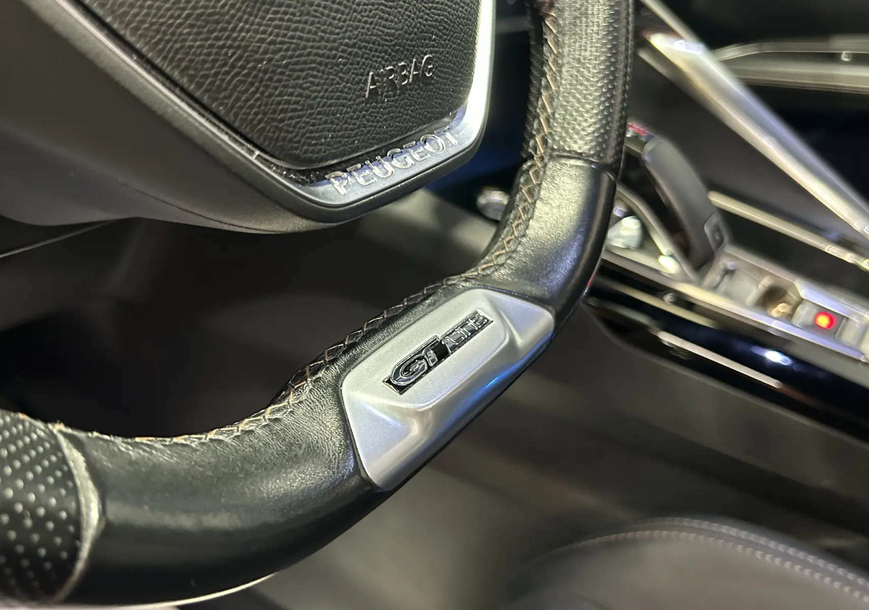 Gros plan sur le volant en cuir noir du Peugeot 3008 GT Line 2020 avec logo GT Line et détails de coutures apparentes.