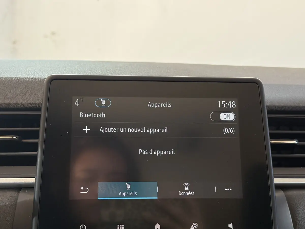 Écran tactile central du tableau de bord du Renault Captur bleu, affichant la connexion Bluetooth activée.