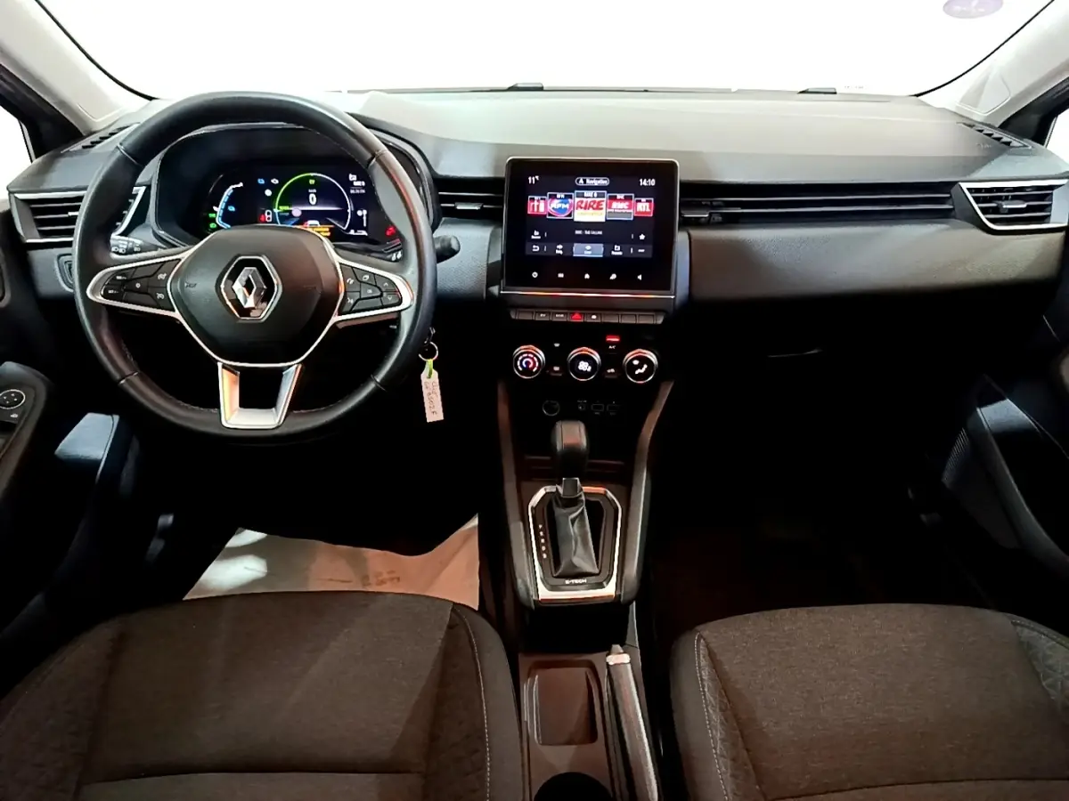 Vue intérieure frontale du tableau de bord de la Renault Clio Business E-TECH 140, avec volant multifonctions et écran tactile central.