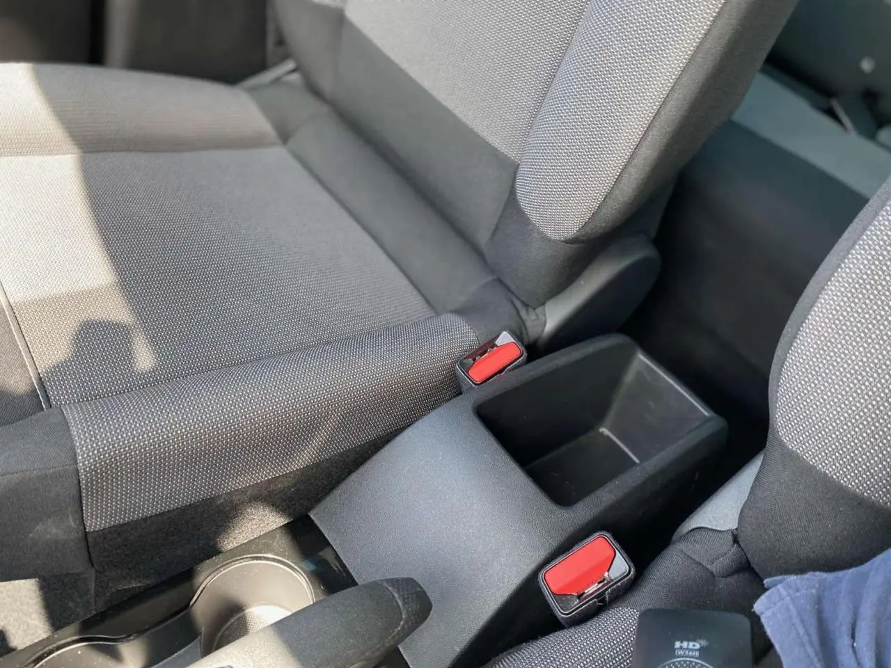 Gros plan sur la console centrale entre les sièges avant gris foncé du Citroën C3 Aircross 2023 finition Shine.