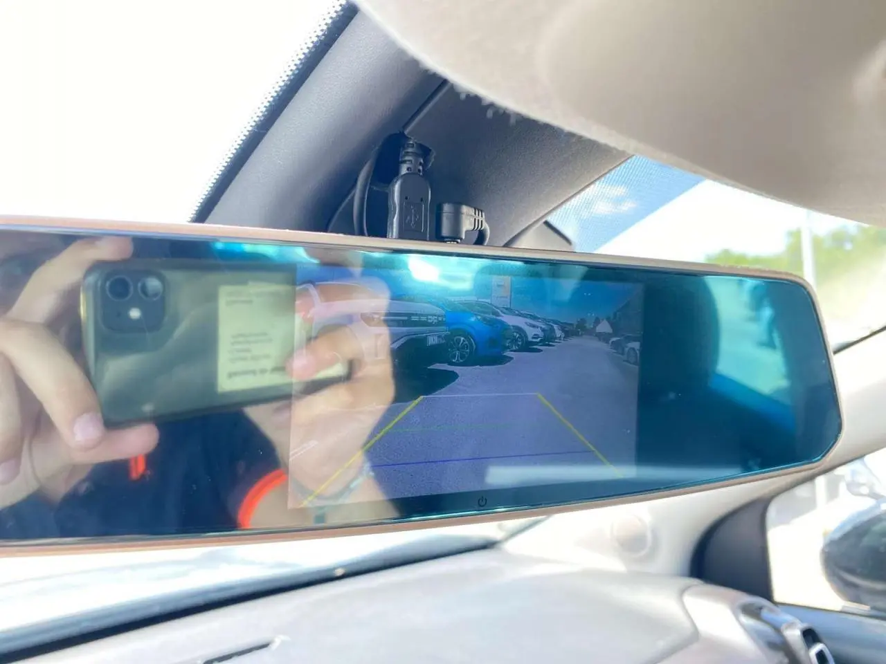 Rétroviseur intérieur numérique affichant la caméra de recul du Citroën C3 Aircross gris avec toit blanc, vue arrière du parking.