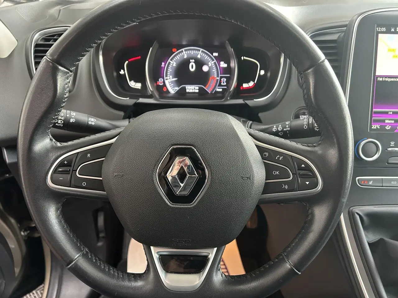 Vue rapprochée du volant noir du Renault Scenic Grand IV 2017 avec tableau de bord numérique et écran tactile latéral.