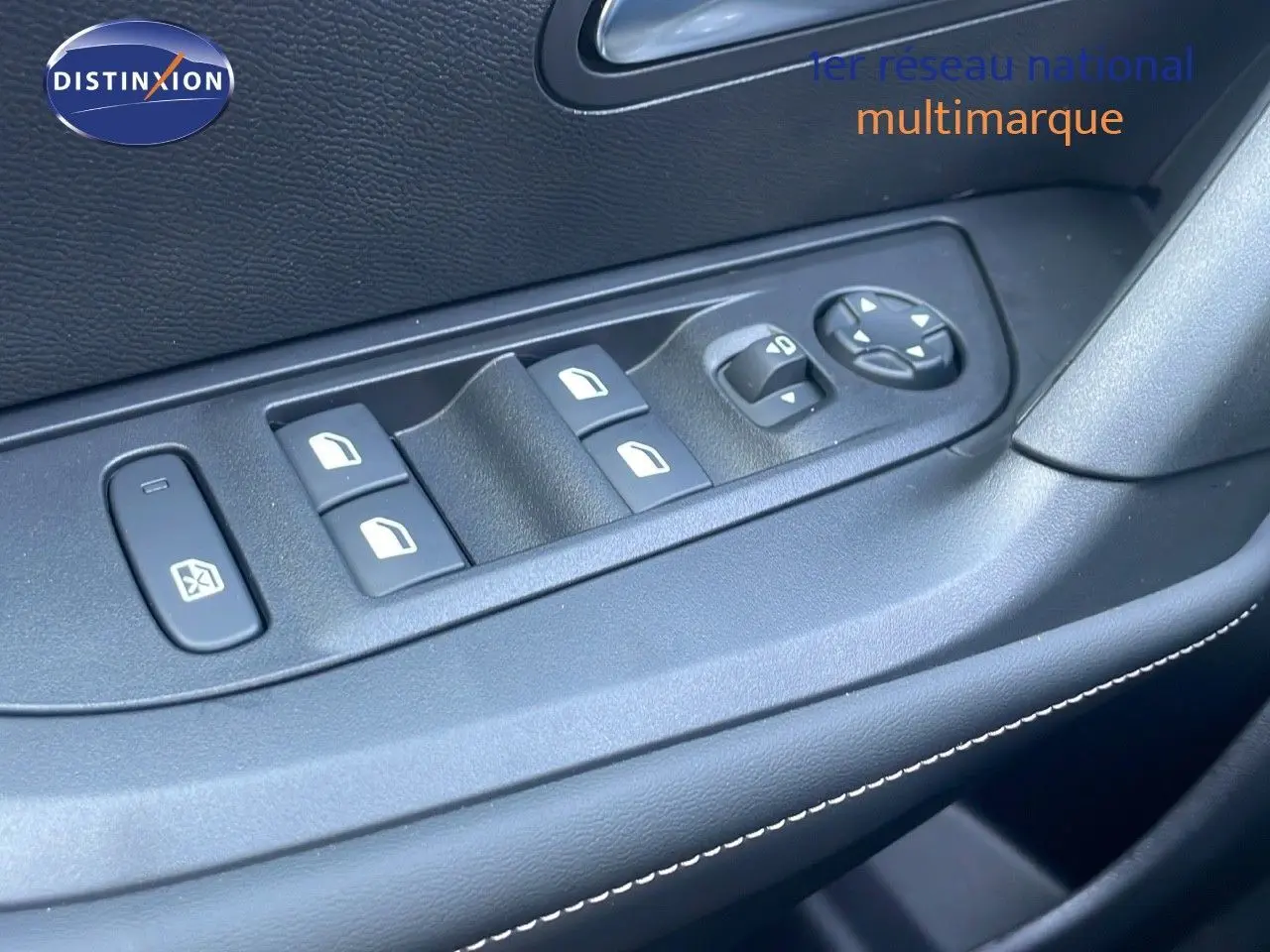 Gros plan sur les commandes de lève-vitres et réglage des rétroviseurs côté conducteur du Peugeot 2008 gris Artense 2025.