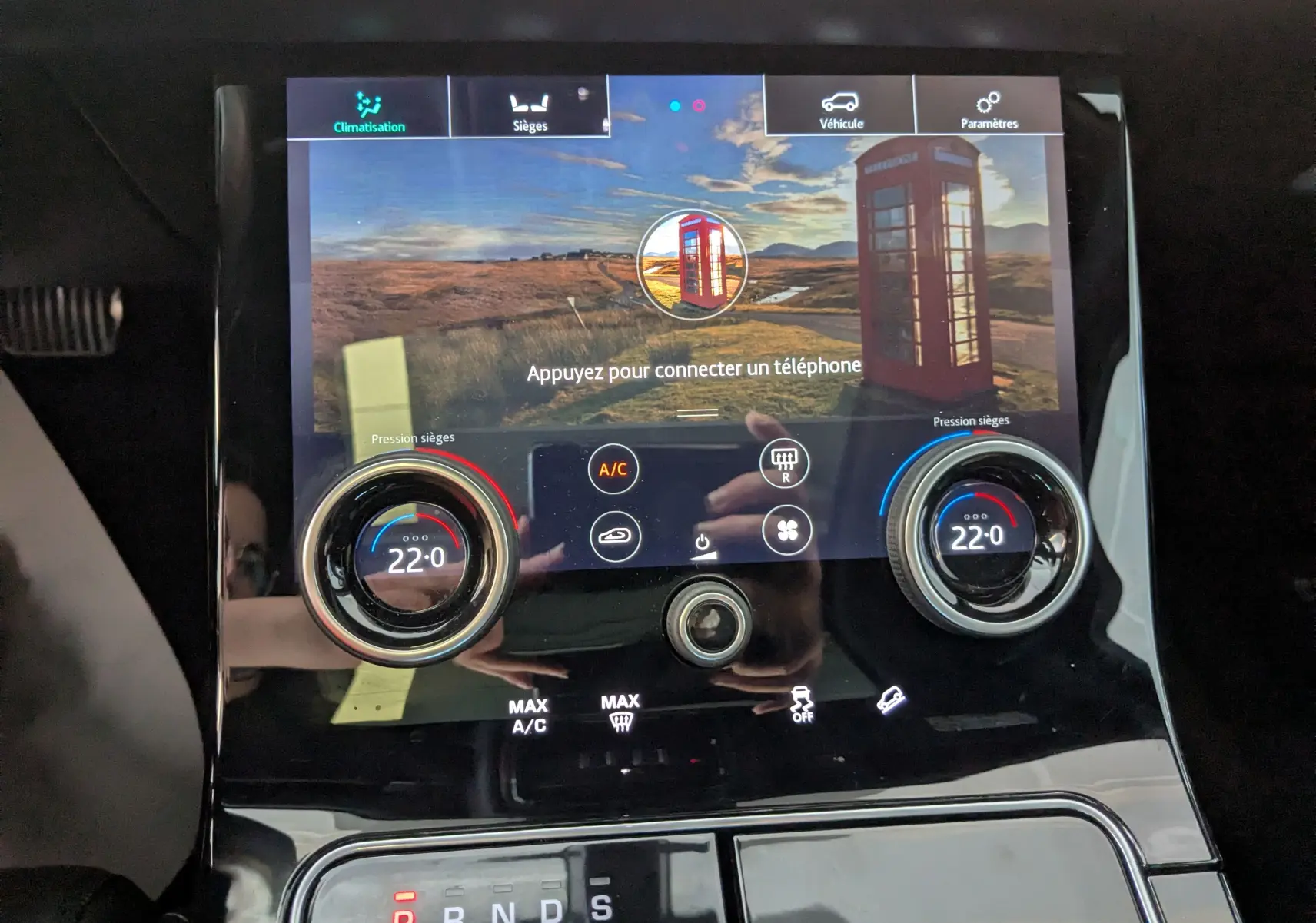 Écran tactile central du Range Rover Velar noir 2020 montrant les réglages de climatisation et sièges chauffants à 22°C.